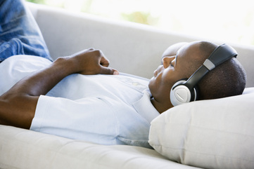 Person relaxing listening to binaural beats