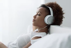 Woman relaxed listening to binaural beats